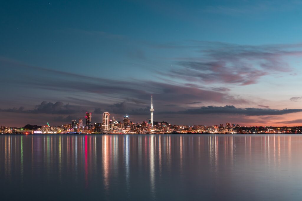 Auckland, New Zealand at night. The cheapest time to visit New Zealand is between May and October. 