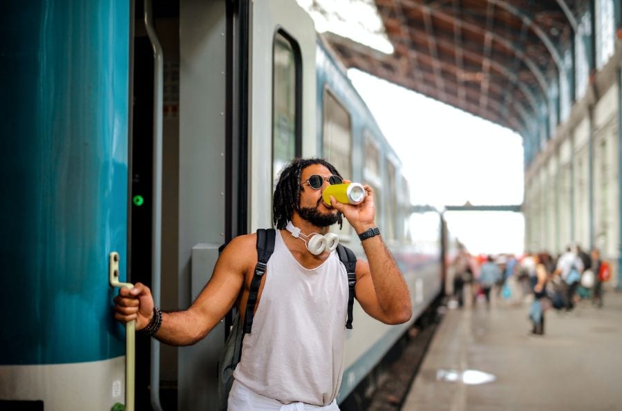 Man hanging off a train in France while drinking a can of something. Can you drink legally in public in France?