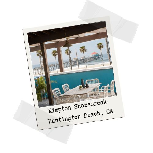 A balcony with a table and chairs overlooking the ocean at Kimpton Shorebreak, Huntinton Beach, CA.