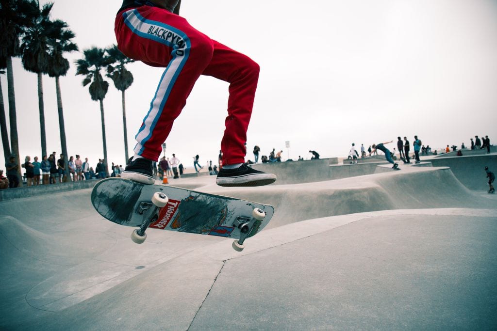 A skateboarder's legs and feet in mid-air skating in Venice Beach Skatepark, California. 