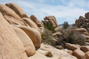 Large rock formation enclose the path at Hidden Valley in Joshua Tree National Park.