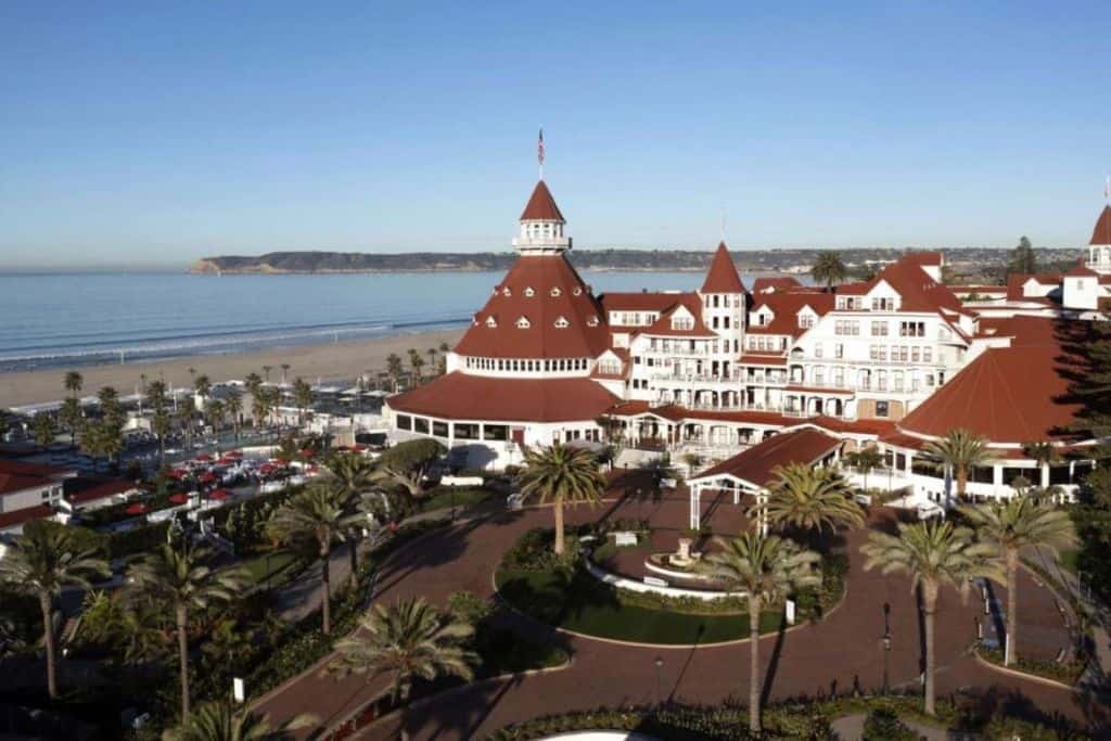 Hotel del Coronado in San Diego with the beach behind it .