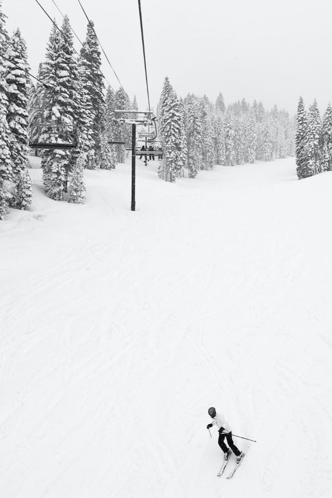 A skier going down a very snowy mountain alone. 