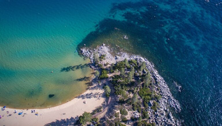 A picture of a lake from above, and part of the beach.
