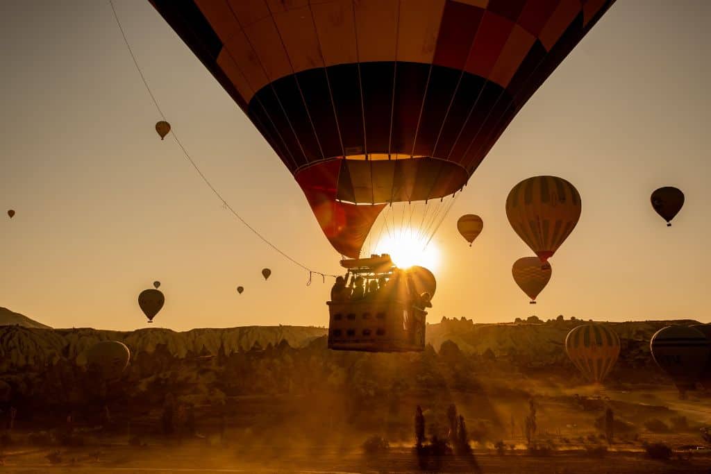 A hot air balloon takes off during sunrise on this Skyward at Sunrise Balloon Tour in Temecula, California.