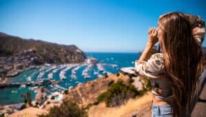 A woman taking a picture of the town of Avalon on her two days on Catalina Island.