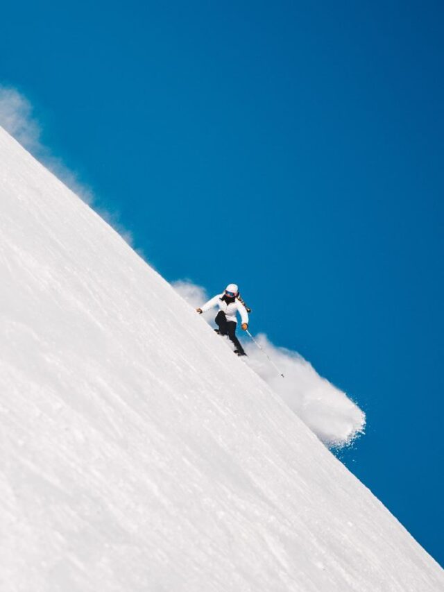 a woman skiing down hill.
