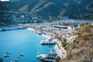 A beautiful island with rolling hills and boats in the harbor.