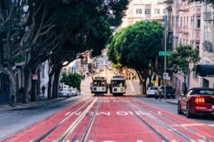 Two cable cars in San Francisco passing each other on the street.