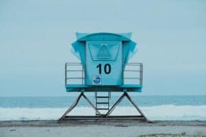 A pale blue lifeguard stand with the number 10 on it sits vacant at Venice Beach in Los Angeles, California.