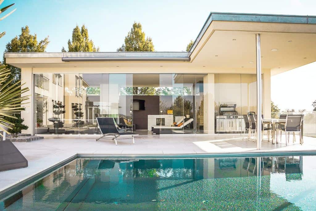 A beautiful pool by a modern house. 